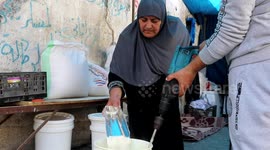 An elderly Palestinian woman, Maryam Salaha, 56, prepares to sell her own home-made Qatayef, traditional Arabic dumplings, during the Muslim holy fasting month of Ramadan