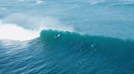 Stunning drone video shows pod of dolphins sharing waves with surfers in Western Australia