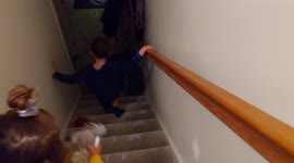 2 kids brother and sister going downstairs on Christmas morning to discover Santa's footsteps and find presents