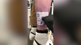 UK tattoo artist inks Will Smith slapping Chris Rock onto a man's leg