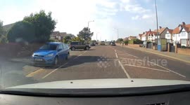 Car drives off with boot open and bags fall out into road.  Caught on Dash Cam