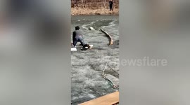 Dog owner and nearby residents rescue golden retriever trapped in frozen lake