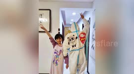Chinese father wears protective clothing covered in daughter's doodles