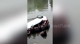 Passersby in China dive into river to save motorists trapped in sinking car