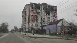 Ukrainian drives through ruins of destroyed cities surrounding Kyiv