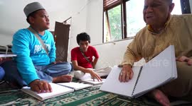 Indonesian Muslims with visual impairments recite Quran written in braille during Ramadan