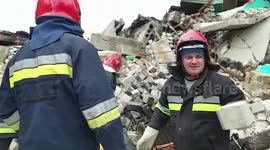 Ukrainian emergency workers clear rubble of destroyed apartment blocks in Borodyanka