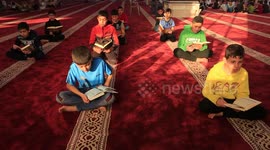 Palestinian children read holy Koran in a mosque during the holy month of Ramadan, in Khan Younis in the southern of Gaza Strip