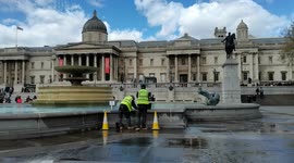 Cleaner, cleaning the fountain in Trafalgar Square