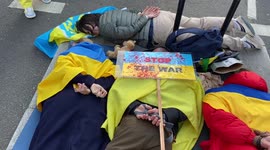 Protesters stage die in and throw children's toys in front of Russian Embassy in London