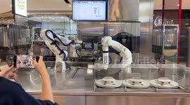 Robot baristas prepare coffee for customers in Thailand