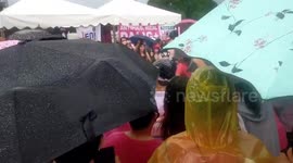 Locals brave rain to attend election rally for Philippine vice president running against controversial dictator's son
