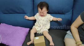 Funny 10-month-old terrified of a piggy bank's cat