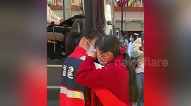 Medical workers hug their families before departing to support Shanghai