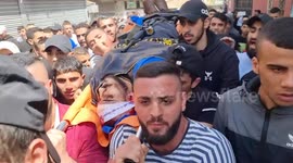 Mourners carry the body of 25-year-old Palestinian Ahmed al-Saadi, who was killed earlier during clashes with Israeli forces, during the funeral in the Palestinian refugee camp of Jenin