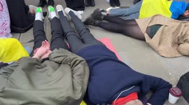 Ukrainian protesters lay on the ground outside Downing Street as they protest against the war and the Bucha Massacre