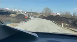 Makeshift road built next to damaged bridge reconnects Irpin to Kyiv