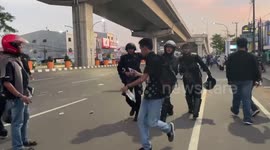 Demonstrators pelt riot police with stones in Makassar during election protest