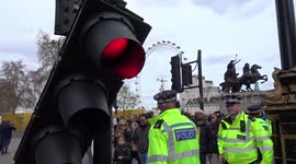Traffic lights dangle in the air after road incident outside the Houses of Parliament in London