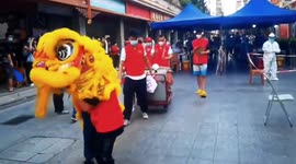 Chinese volunteers lion dance through streets to encourage residents to take COVID-19 tests