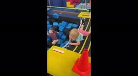 'Toddler trips and flips while jumping into the foam pit '