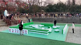 Chinese tourists play giant mahjong in scenic square