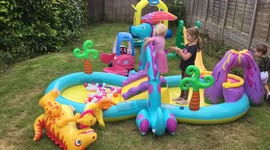 Child / toddler falls off the inflatable slide flat on her face - child hurt - funny
