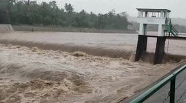 Floodwaters gush under bridge during Tropical Storm Megi in the Philippines