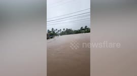 Rescuers help locals through waist-deep floods as Tropical Storm Megi batters the Philippines