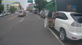 CLOSE CALL: Car door opens almost hitting a passing moped rider (Dashcam Video)
