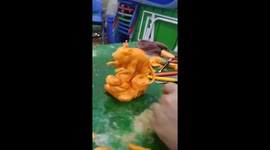 Vietnamese man sculpts carrot into detailed scene featuring mouse