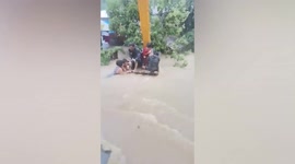 Stranded locals rescued with backhoe as Tropical Storm Megi hits the Philippines