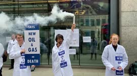 Scientists glue themselves to government building in London during Extinction Rebellion protest