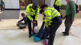 Police attempt to remove Extinction Rebellion activists glued outside Shell HQ in London