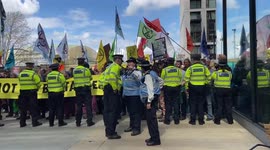 Police officers form barrier outside Shell HQ during Extinction Rebellion protest