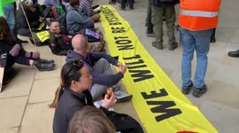 Extinction Rebellion activists glue themselves to Shell HQ during climate protest