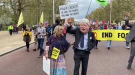 Extinction Rebellion protesters dressed as Boris Johnson and other UK politicians march through London