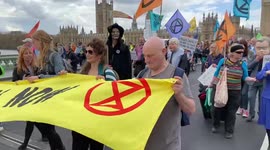 Extinction Rebellion protesters dressed as Priti Patel and other UK politicians march through London