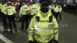 female protesters carried  by police in Trafalgar square london