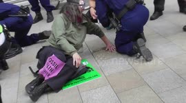 female police officer frees the hand of a female protester shell hq london extinction rebellion