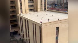 Children seen roller skating on rooftop and throwing objects onto the ground in China