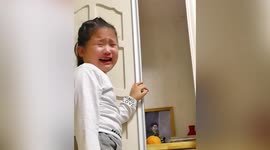Chinese girl bursts into tears after opening wardrobe and seeing photo of her late grandma