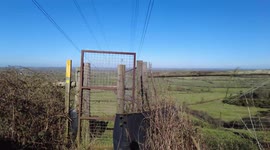 Look at a stunning countryside on a sunny view and the impact of pylons on the land scape.