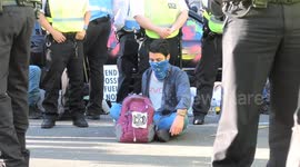 XR protesters glued to the road and a car at Marble Arch