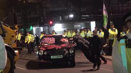 Police use a JCB crane to drag away limousine from Marble Arch in London during Extinction Rebellion protest
