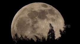 Incredible extreme close-up of full moon rising in Swiss Alps