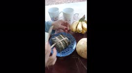 Unwrapping a delicious Thai snack that has neen beautifully wrapped in many layers of banana tree leaves.