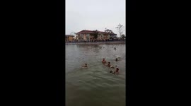 Dozens of young people participate in the duck catching festival under the lake in Vietnam