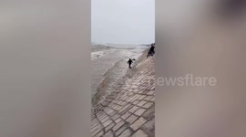 Lucky Chinese woman rescued after Qiantang tide knocks her down