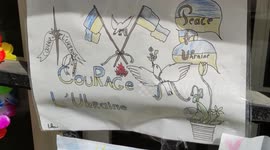 Kids leave peace messages and flowers at Ukrainian Embassy in Paris